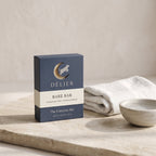 Bare Bar soap box on a stone slab with a linen towel